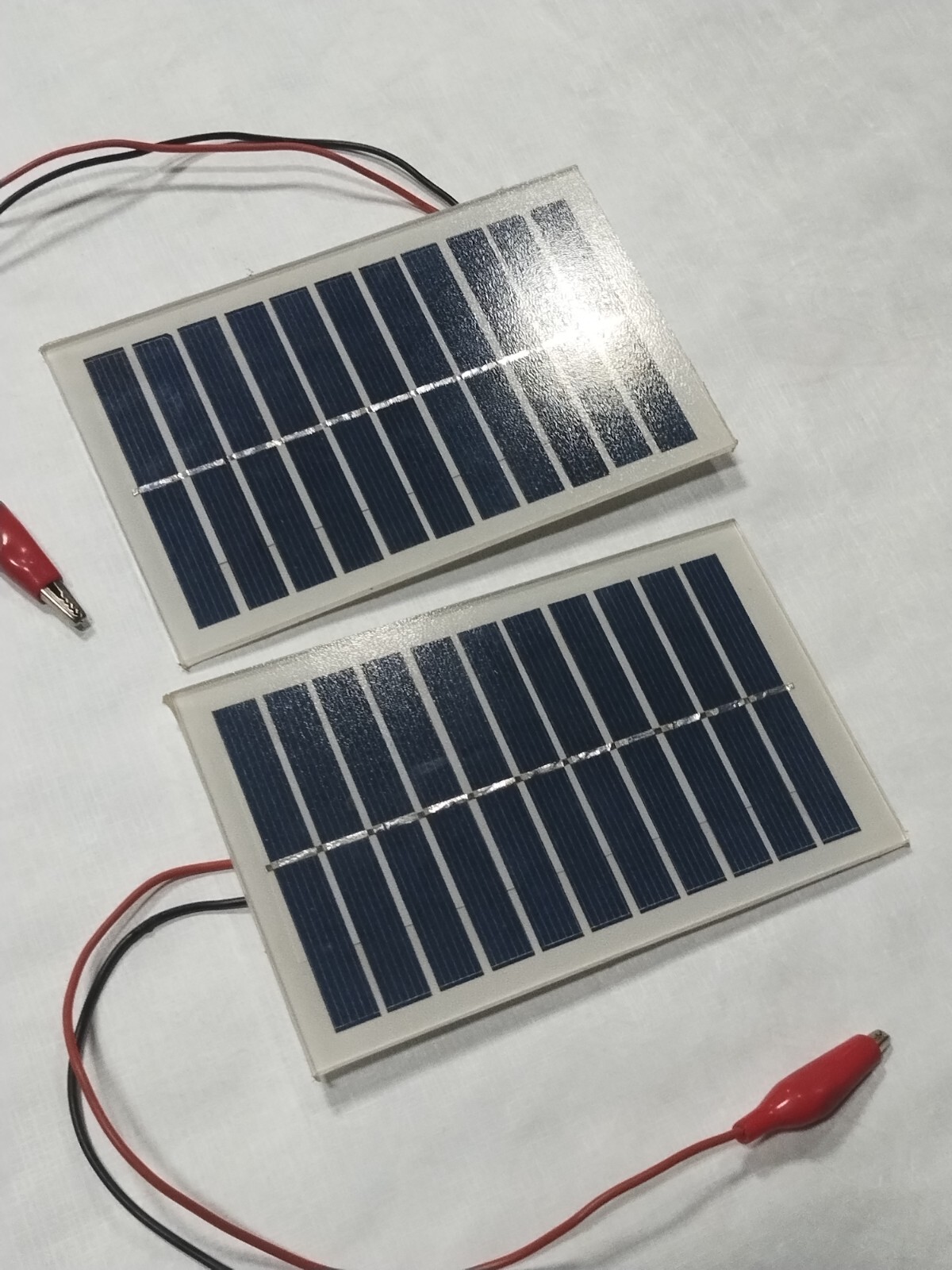 two small 6v solar panels with alligator clips glass